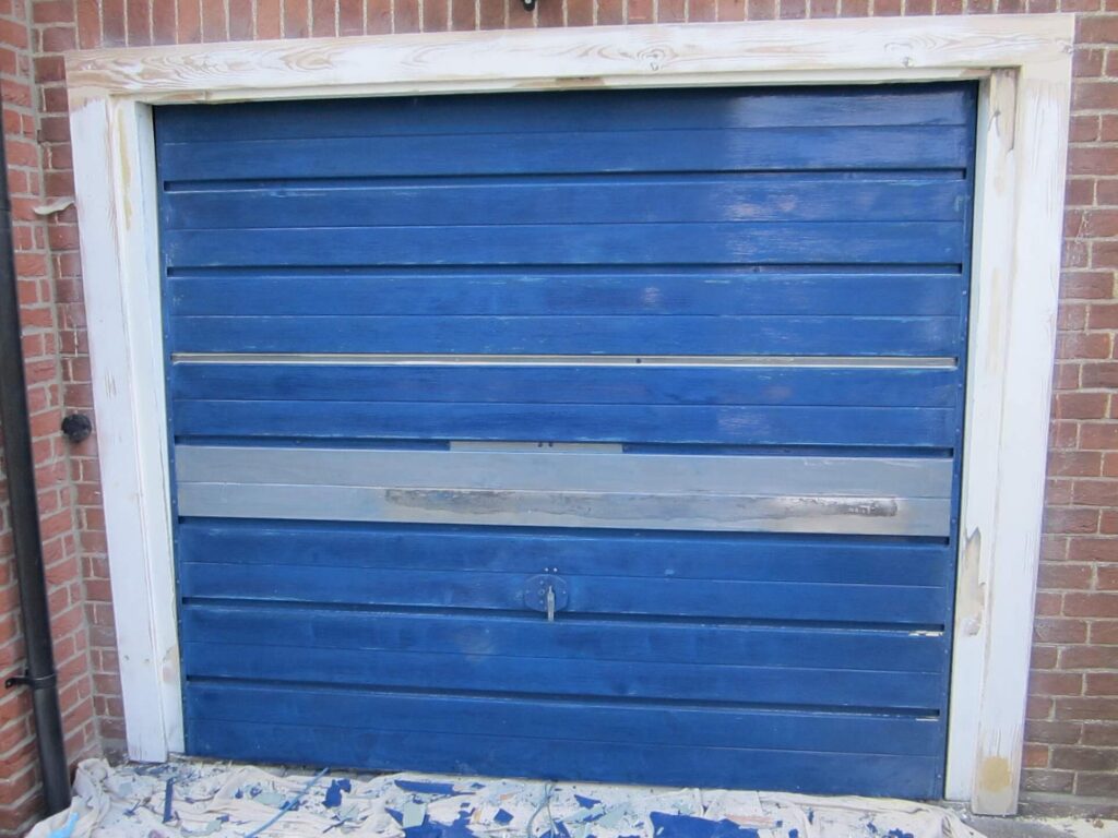 Remove old paint from the metal garage door