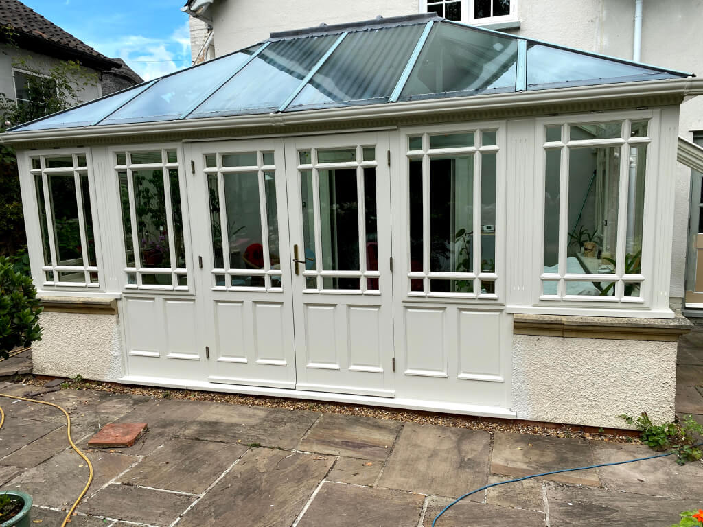 freshly re-decorated conservatory with set of French doors