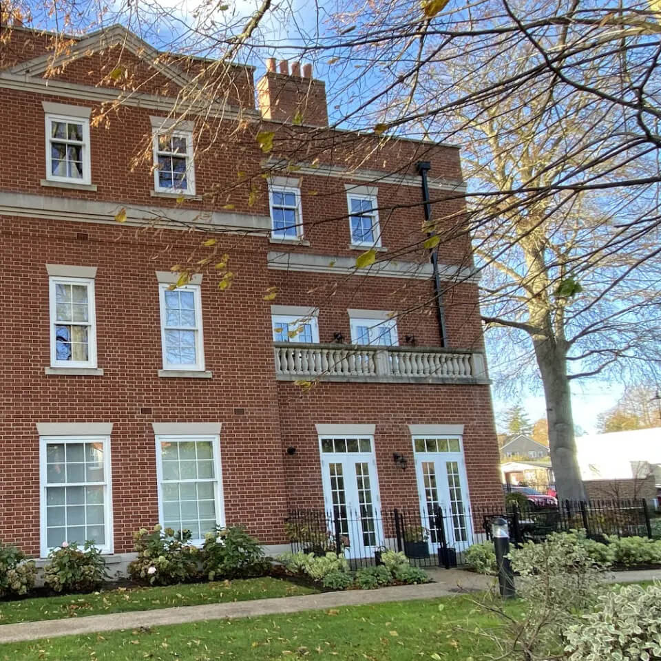 A large red brick house with restored sash windows in Woking park.