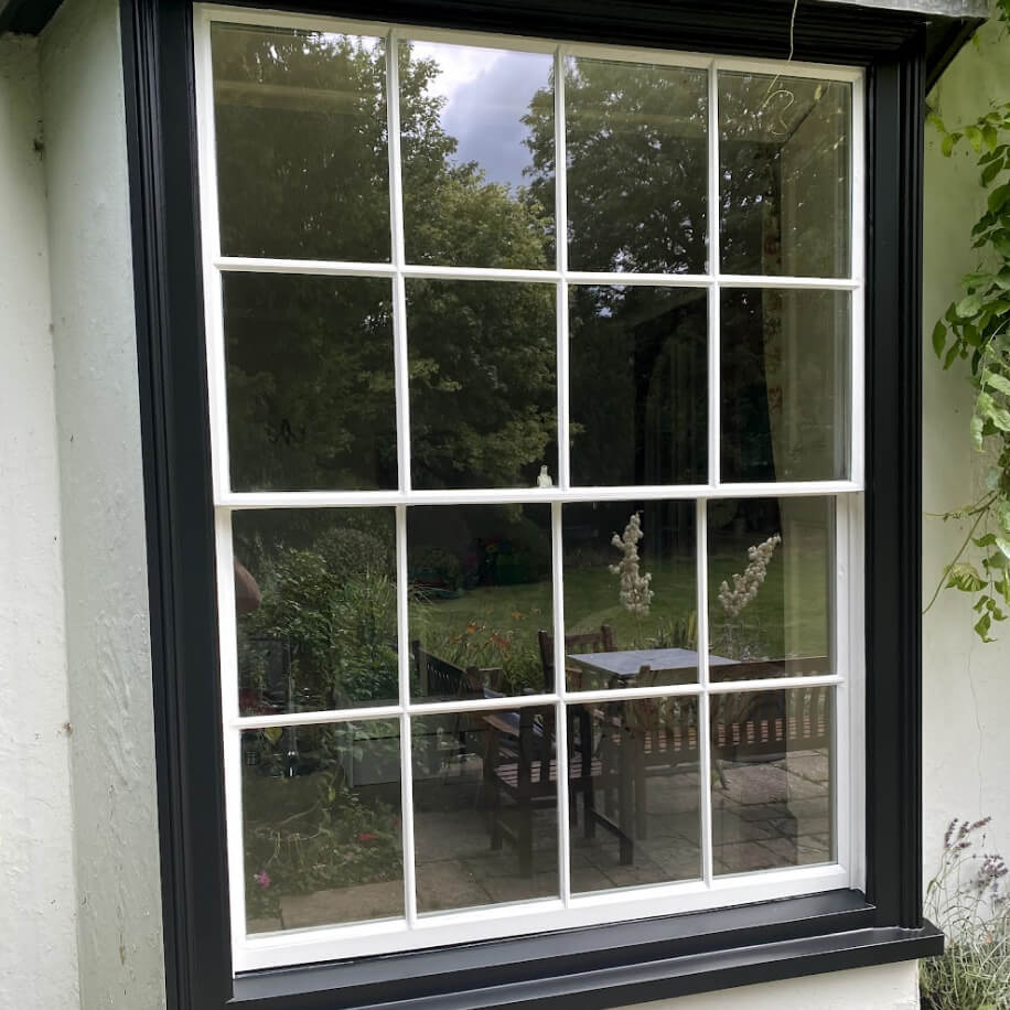A black-framed window with white trim.